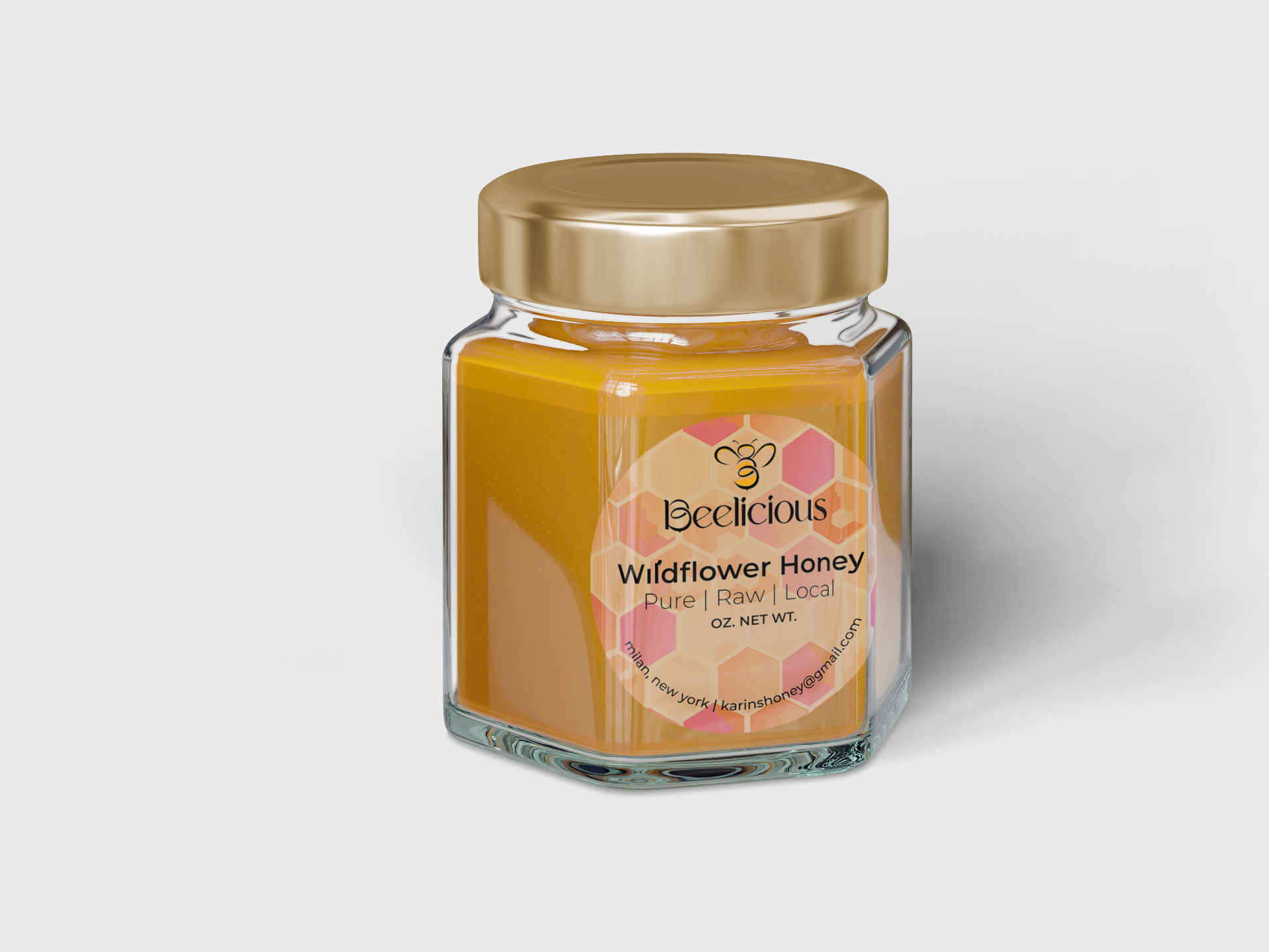 A hex jar of raw wildflower honey with wood dipper